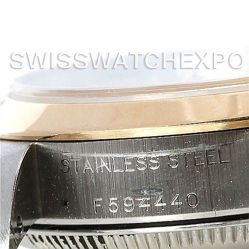 The image displays a close-up of the side of a Rolex Oyster Perpetual 76183 Women's Steel and Gold (two tone) Silver Dial 76183 Women's Steel and Gold (two tone) Silver Dial watch, showing the stainless steel case and engraved serial number.