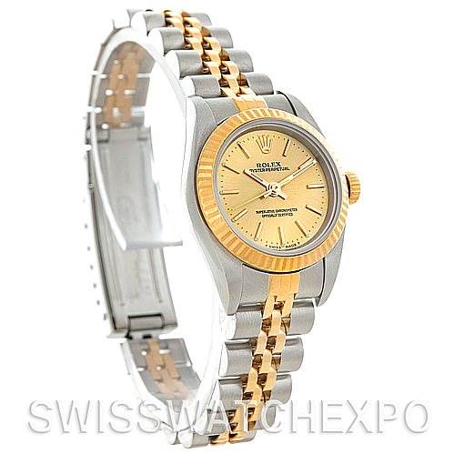 The image shows a Rolex Oyster Perpetual 76193 Women's Steel and Gold (two tone) Champagne Dial 76193 Women's Steel and Gold (two tone) Champagne Dial watch at a slight angle, highlighting its two-tone bracelet, gold dial, and bezel.