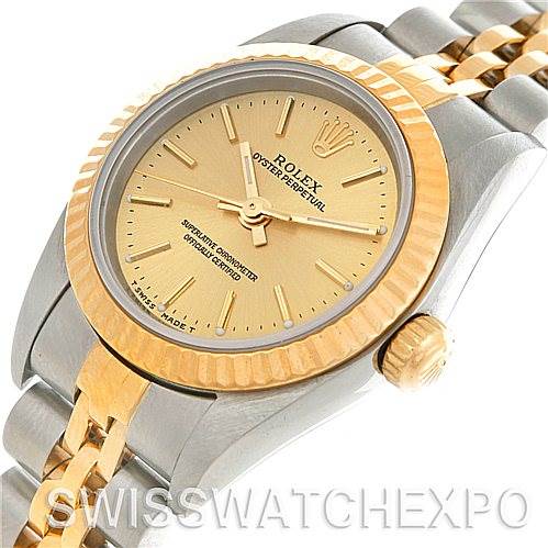 This image shows a close-up view of a Rolex Oyster Perpetual 76193 Women's Steel and Gold (two tone) Champagne Dial 76193 Women's Steel and Gold (two tone) Champagne Dial watch, highlighting the gold dial, bezel, and two-tone bracelet.