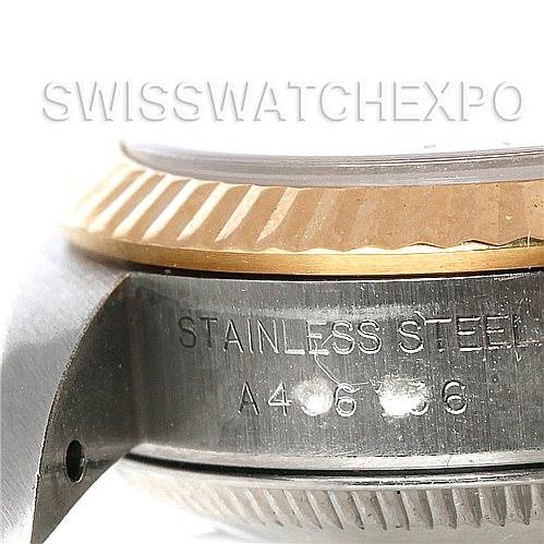 This image shows a close-up side view of a Rolex Oyster Perpetual 76193 Women's Steel and Gold (two tone) Champagne Dial 76193 Women's Steel and Gold (two tone) Champagne Dial watch, highlighting the fluted bezel and stainless steel case with engraved serial number.