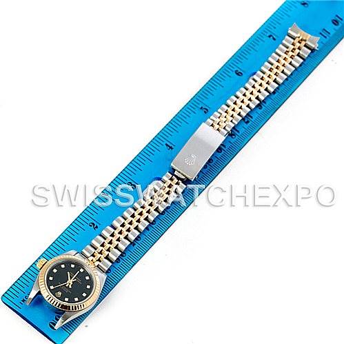 The image shows a top-down view of a Rolex Oyster Perpetual 76193 Women's Steel and Gold (two tone) Black Dial 76193 Women's Steel and Gold (two tone) Black Dial watch laid flat on a blue ruler.