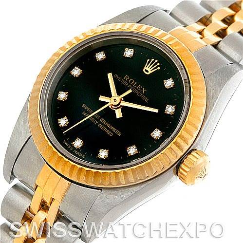 The image shows a close-up view of a Rolex Oyster Perpetual 76193 Women's Steel and Gold (two tone) Black Dial 76193 Women's Steel and Gold (two tone) Black Dial watch, highlighting the dial, bezel, crown, and part of the bracelet.