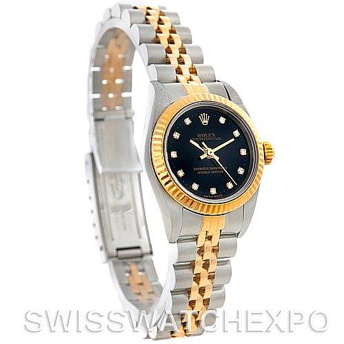 This image shows a Rolex Oyster Perpetual 76193 Women's Steel and Gold (two tone) Black Dial 76193 Women's Steel and Gold (two tone) Black Dial watch at a side angle, highlighting its two-tone bracelet, black dial, and fluted bezel.