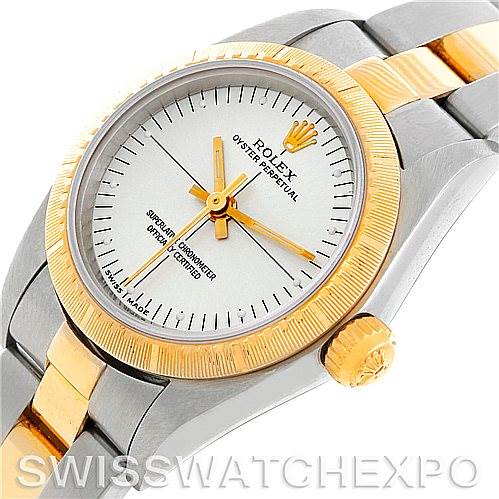 This image shows a diagonal top-down view of the Rolex Oyster Perpetual 76243 Women's Steel and Gold (two tone) Silver Dial 76243 Women's Steel and Gold (two tone) Silver Dial watch, focusing on its dial, bezel, and part of the bracelet.