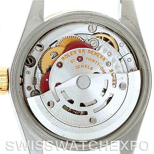 This is an image of the internal mechanism of a Rolex Oyster Perpetual 76243 Women's Steel and Gold (two tone) Silver Dial 76243 Women's Steel and Gold (two tone) Silver Dial watch, showing gears and the rotor.