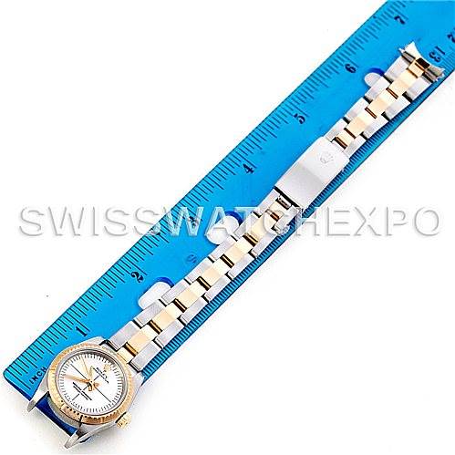 The image shows a Rolex Oyster Perpetual 76243 Women's Steel and Gold (two tone) Silver Dial 76243 Women's Steel and Gold (two tone) Silver Dial watch placed alongside a blue ruler, highlighting the watch face and bracelet.