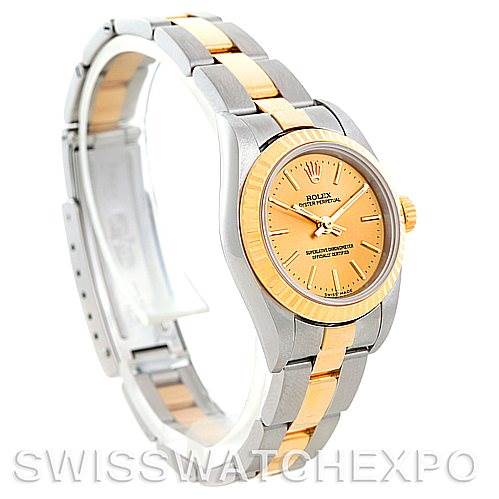 The image shows a side angle of a Rolex Oyster Perpetual 76193 Women's Steel and Gold (two tone) Champagne Dial 76193 Women's Steel and Gold (two tone) Champagne Dial watch, highlighting the two-tone bracelet and champagne-colored dial.