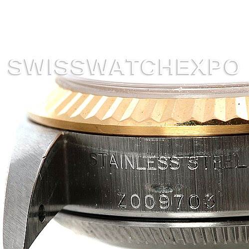 The image shows a close-up of the side of a Rolex Oyster Perpetual 76193 Women's Steel and Gold (two tone) Champagne Dial 76193 Women's Steel and Gold (two tone) Champagne Dial watch, highlighting the stainless steel case and gold bezel.