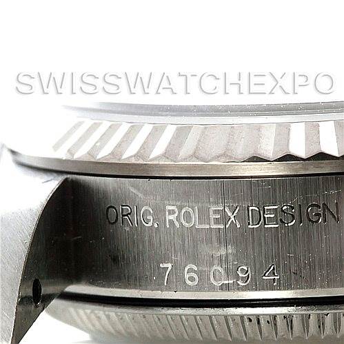 This image shows a close-up side view of a Rolex Oyster Perpetual 76094 Women's Stainless Steel White Dial 76094 Women's Stainless Steel White Dial watch case, highlighting the "ORIG. ROLEX DESIGN" engraving and serial number.