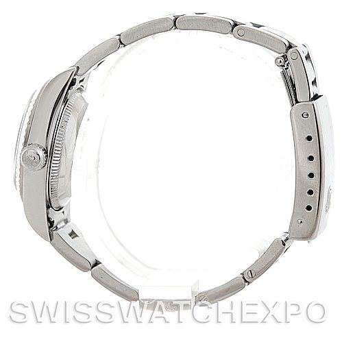 The image shows a side view of a Rolex Oyster Perpetual 76094 Women's Stainless Steel White Dial 76094 Women's Stainless Steel White Dial watch highlighting the case, crown, and bracelet clasp.