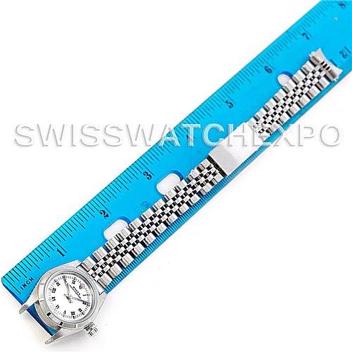 The image shows a top-view angle of a Rolex Oyster Perpetual 76030 Women's Stainless Steel White Dial 76030 Women's Stainless Steel White Dial watch, including the watch face and bracelet placed next to a blue ruler.