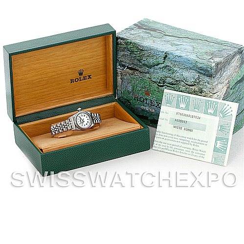 The image shows a Rolex Oyster Perpetual 76030 Women's Stainless Steel White Dial 76030 Women's Stainless Steel White Dial watch in its open green box, with papers displayed next to it.