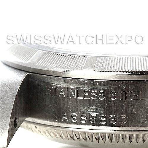 This image shows a close-up of the side of a Rolex Oyster Perpetual 76030 Women's Stainless Steel White Dial 76030 Women's Stainless Steel White Dial watch, highlighting the stainless steel inscription and serial number.