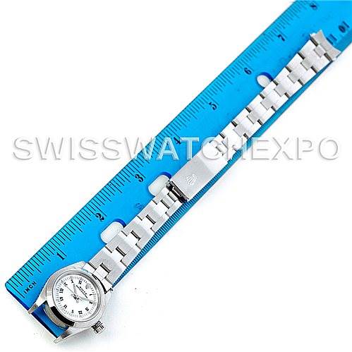 The image shows a Rolex Oyster Perpetual 76080 Women's Stainless Steel White Dial 76080 Women's Stainless Steel White Dial watch laid flat with its band aligned next to a blue ruler for measurement.