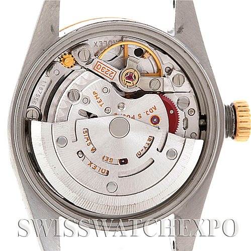 The image shows the back view of the Rolex Oyster Perpetual 76193 Women's Steel and Gold (two tone) Black Dial 76193 Women's Steel and Gold (two tone) Black Dial watch, highlighting its internal movement mechanism.