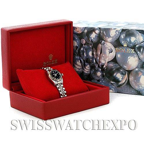 The image shows a Rolex Oyster Perpetual 76193 Women's Steel and Gold (two tone) Black Dial 76193 Women's Steel and Gold (two tone) Black Dial watch in a red presentation box along with its decorative packaging.