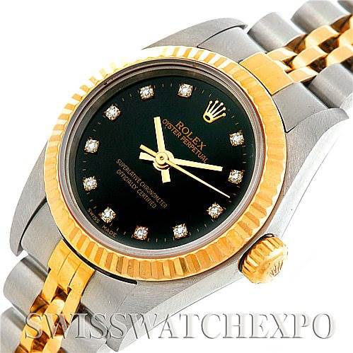 The image shows a close-up of a Rolex Oyster Perpetual 76193 Women's Steel and Gold (two tone) Black Dial 76193 Women's Steel and Gold (two tone) Black Dial watch, highlighting its face, bezel, and bracelet at a slight angle.