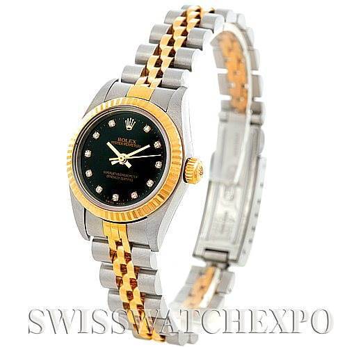 This Rolex Oyster Perpetual 76193 Women's Steel and Gold (two tone) Black Dial 76193 Women's Steel and Gold (two tone) Black Dial watch is shown from an angled side view, displaying its bracelet, case, crown, and dial.