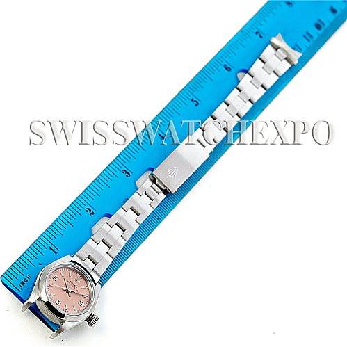 The image shows an overhead view of a Rolex Oyster Perpetual 76080 Women's Stainless Steel Pink Dial 76080 Women's Stainless Steel Pink Dial watch placed alongside a blue ruler for measurement.