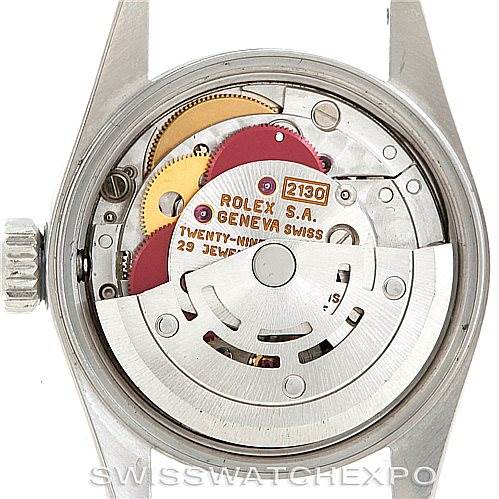 The image shows the inner mechanism of a Rolex Oyster Perpetual 67180 Women's Stainless Steel Silver Dial 67180 Women's Stainless Steel Silver Dial watch from the back angle, revealing the movement parts.