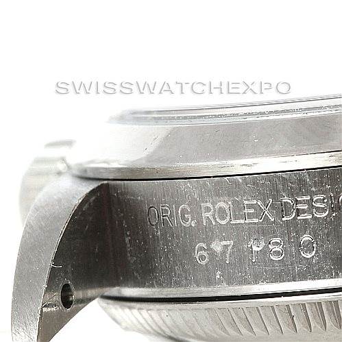 This image shows a close-up of the side and lugs of a Rolex Oyster Perpetual 67180 Women's Stainless Steel Silver Dial 67180 Women's Stainless Steel Silver Dial watch, highlighting the engraved text on the case.