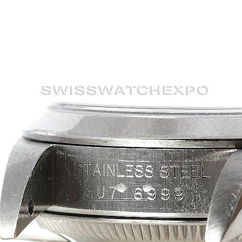 This image shows a close-up side angle of the case and lugs of a Rolex Oyster Perpetual 67180 Women's Stainless Steel Silver Dial 67180 Women's Stainless Steel Silver Dial watch, highlighting the "Stainless Steel" engraving.