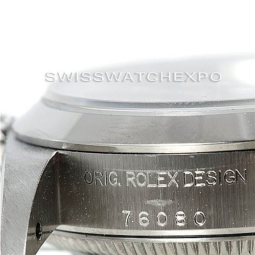 This image shows a close-up side view of the case of a Rolex Oyster Perpetual 76080 Women's Stainless Steel Black Dial 76080 Women's Stainless Steel Black Dial watch, displaying the engraving "ORIG. ROLEX DESIGN" and "76080".