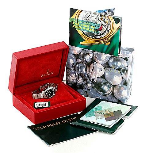 The image shows a Rolex Oyster Perpetual 76080 Women's Stainless Steel Black Dial 76080 Women's Stainless Steel Black Dial watch in its open red box, accompanied by various booklets and a decorated outer box.