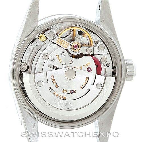 This image shows the back view of a Rolex Oyster Perpetual 76080 Women's Stainless Steel Black Dial 76080 Women's Stainless Steel Black Dial watch, displaying its intricate internal mechanics and movement.