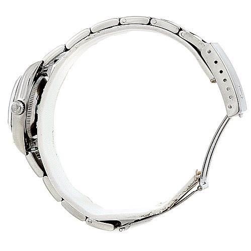 The image shows a side view of the Rolex Oyster Perpetual 76080 Women's Stainless Steel Black Dial 76080 Women's Stainless Steel Black Dial watch, highlighting the bracelet, case, and crown.