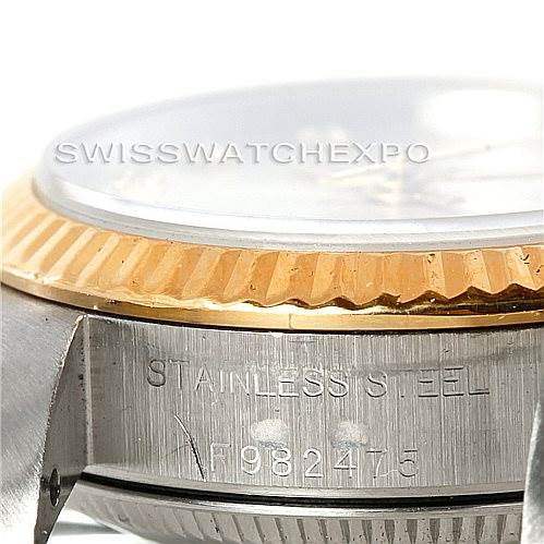 The image shows a close-up side view of a Rolex Oyster Perpetual 76193 Women's Steel and Gold (two tone) Silver Dial 76193 Women's Steel and Gold (two tone) Silver Dial watch, highlighting the stainless steel case and the bezel.