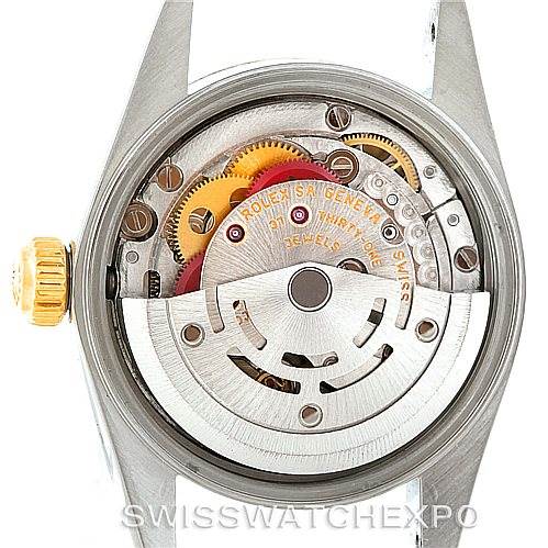 The image shows the back view of a Rolex Oyster Perpetual 76193 Women's Steel and Gold (two tone) Champagne Dial 76193 Women's Steel and Gold (two tone) Champagne Dial watch, revealing its internal movement and rotor.