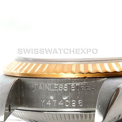 This image shows a close-up side view of a Rolex Oyster Perpetual 76193 Women's Steel and Gold (two tone) Champagne Dial 76193 Women's Steel and Gold (two tone) Champagne Dial watch's case, bezel, and engraved serial number.