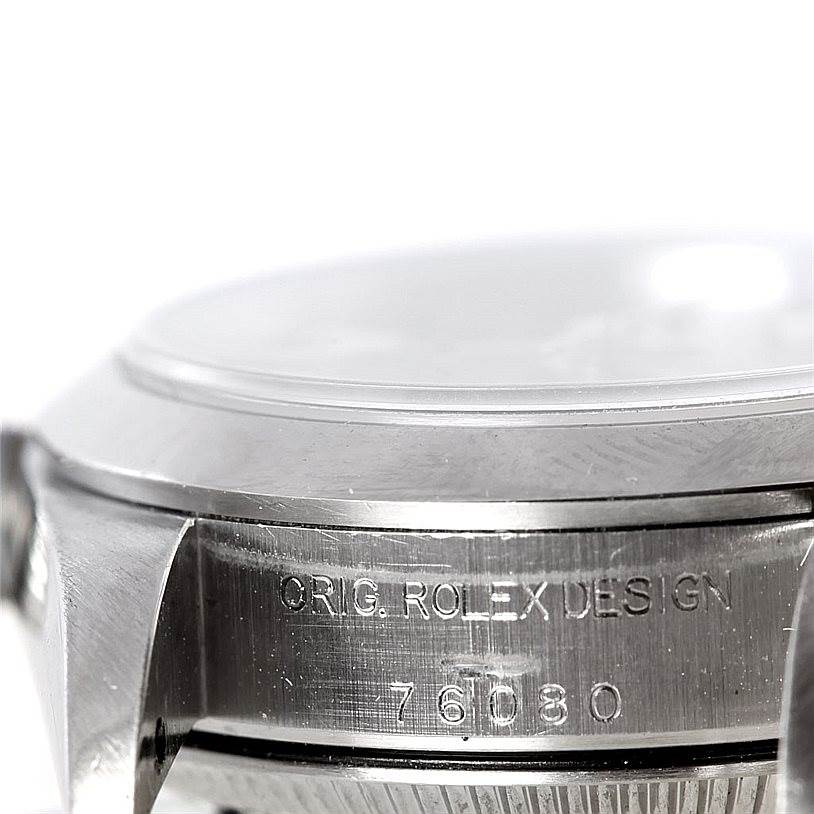 This image shows a close-up of the side and bezel of a Rolex Oyster Perpetual 76080 Women's Stainless Steel Black Dial 76080 Women's Stainless Steel Black Dial watch, highlighting the engraving and model number.