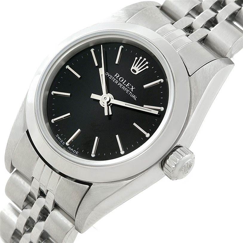 The Rolex Oyster Perpetual 76080 Women's Stainless Steel Black Dial 76080 Women's Stainless Steel Black Dial watch is shown at an oblique angle, highlighting the black dial, crown, and part of the stainless steel bracelet.