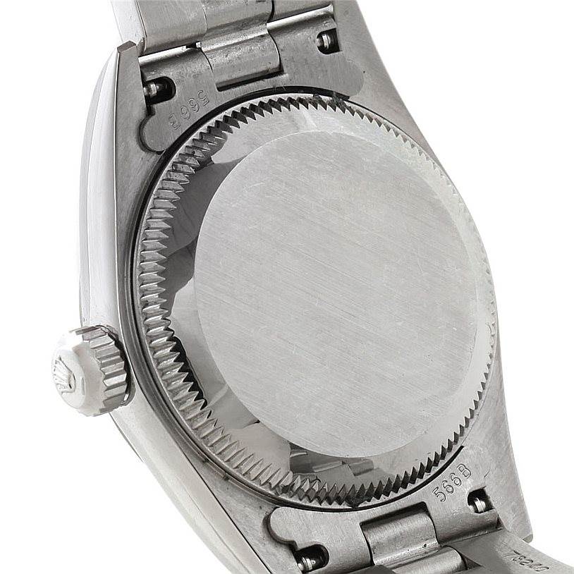 The image shows the back case and crown of a Rolex Oyster Perpetual 76030 Women's Stainless Steel Black Dial 76030 Women's Stainless Steel Black Dial watch from an angled, close-up perspective.