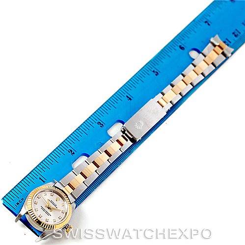 The image shows a Rolex Oyster Perpetual 76193 Women's Steel and Gold (two tone) Silver Dial 76193 Women's Steel and Gold (two tone) Silver Dial watch laid flat against a ruler, displaying the face, bracelet, and clasp.