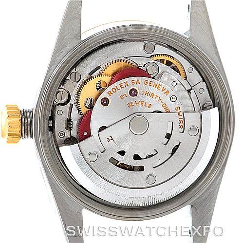 The image shows the internal mechanism and movement of a Rolex Oyster Perpetual 76193 Women's Steel and Gold (two tone) Silver Dial 76193 Women's Steel and Gold (two tone) Silver Dial watch from a back angle.