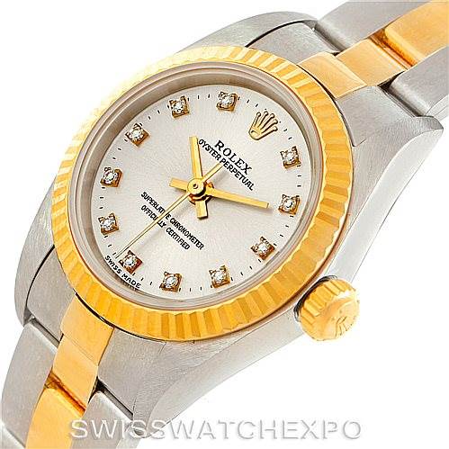 The image shows a Rolex Oyster Perpetual 76193 Women's Steel and Gold (two tone) Silver Dial 76193 Women's Steel and Gold (two tone) Silver Dial watch at an angle highlighting its bezel, dial, hands, crown, and two-tone bracelet.