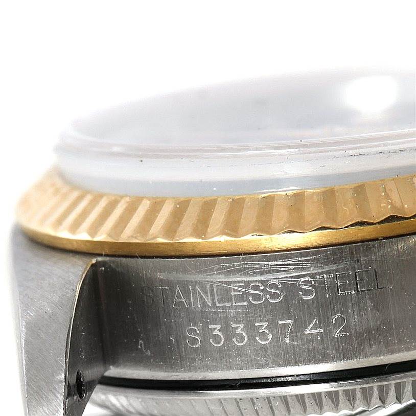 The image shows a close-up angle of the bezel and part of the case back of a Rolex Oyster Perpetual 67193 Women's Steel and Gold (two tone) Black Dial 67193 Women's Steel and Gold (two tone) Black Dial watch.