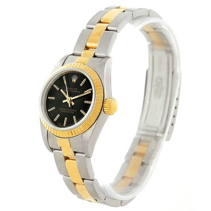 The Rolex Oyster Perpetual 67193 Women's Steel and Gold (two tone) Black Dial 67193 Women's Steel and Gold (two tone) Black Dial watch is shown from a three-quarter angle, highlighting its two-tone band and black dial with gold accents.