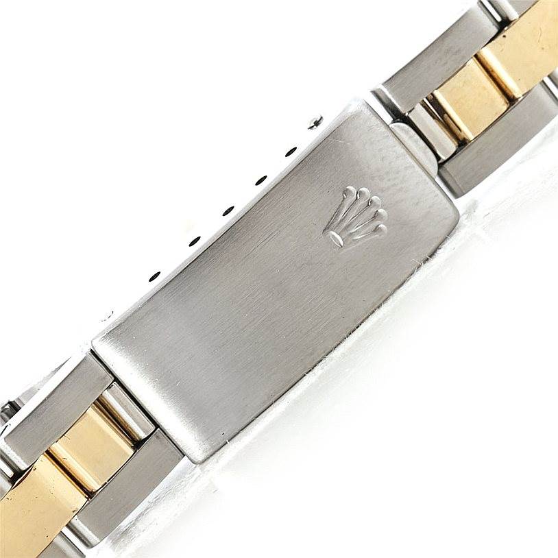 This image shows the clasp of a Rolex Oyster Perpetual 67193 Women's Steel and Gold (two tone) Black Dial 67193 Women's Steel and Gold (two tone) Black Dial watch bracelet in a combination of silver and gold tones.