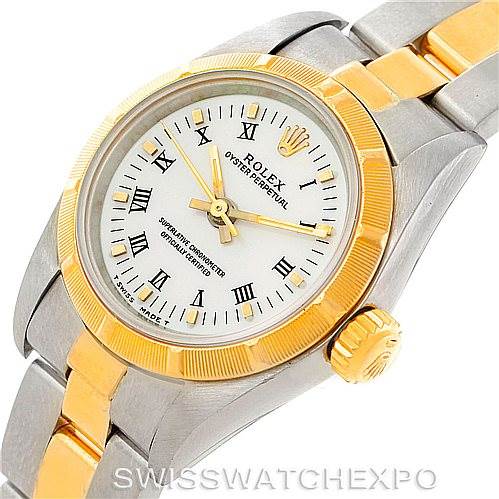 The image shows a close-up of a Rolex Oyster Perpetual 67233 Women's Steel and Gold (two tone) White Dial 67233 Women's Steel and Gold (two tone) White Dial watch angled slightly to the left, highlighting its dial, bezel, and bracelet.