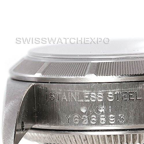 The image shows a close-up side view of the case and bezel of a Rolex Oyster Perpetual 76030 Women's Stainless Steel Silver Dial 76030 Women's Stainless Steel Silver Dial watch, highlighting the stainless steel text and serial number.