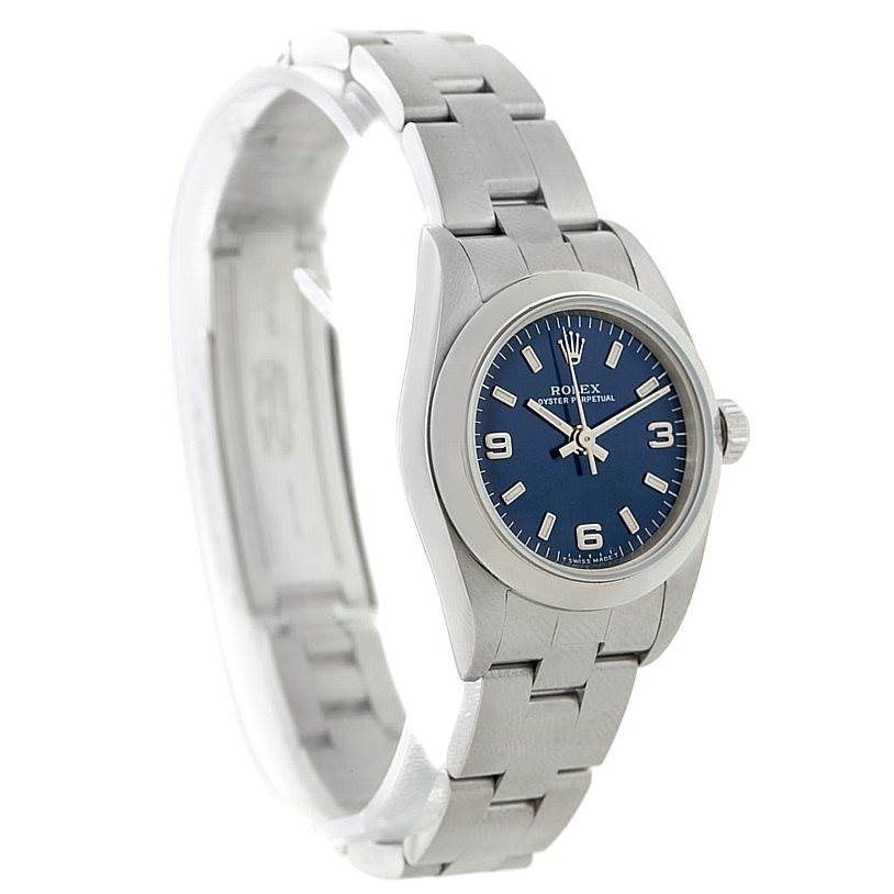 This image shows a side angle of a Rolex Oyster Perpetual 76080 Women's Stainless Steel Blue Dial 76080 Women's Stainless Steel Blue Dial watch, highlighting its silver bracelet and blue dial.