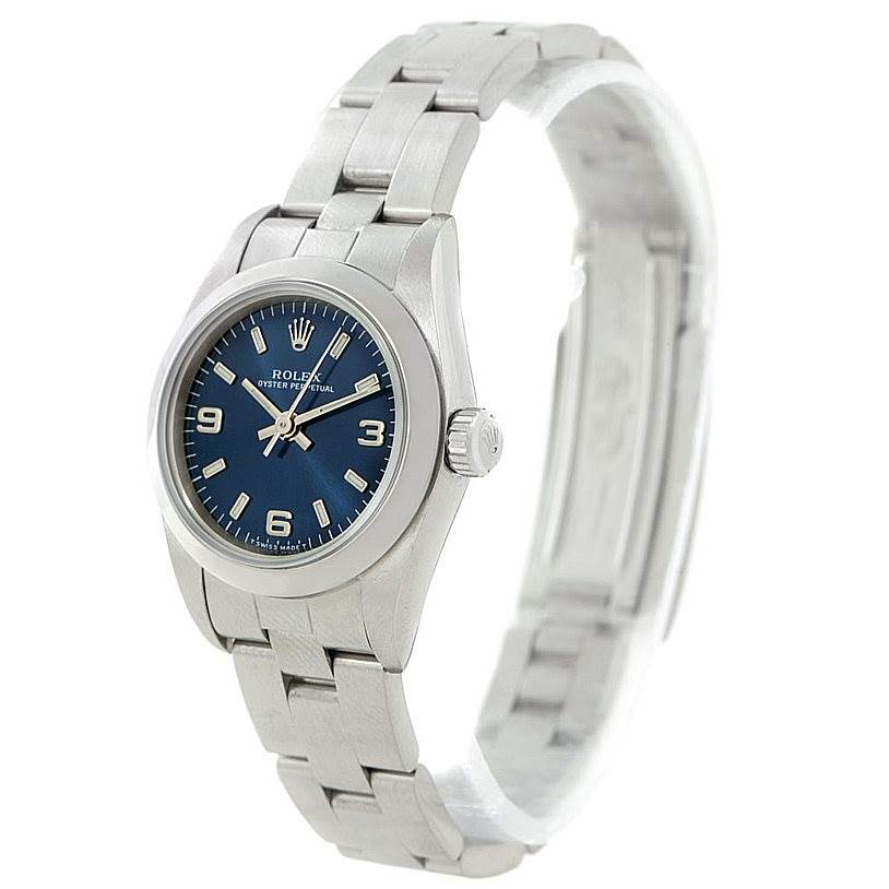 This image shows a Rolex Oyster Perpetual 76080 Women's Stainless Steel Blue Dial 76080 Women's Stainless Steel Blue Dial watch at a three-quarter angle, highlighting its face, crown, and bracelet.