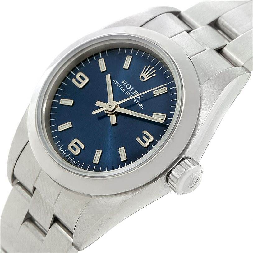 The Rolex Oyster Perpetual 76080 Women's Stainless Steel Blue Dial 76080 Women's Stainless Steel Blue Dial watch is shown from a side angle, displaying its blue dial, crown, and stainless steel bracelet.