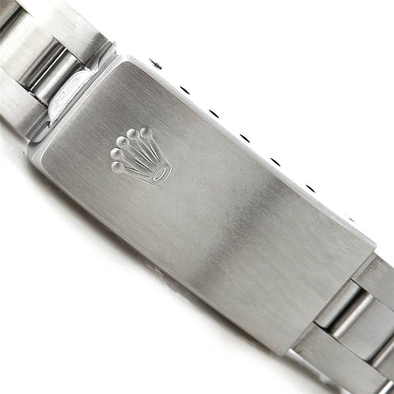The image shows a close-up of the clasp with the Rolex crown logo on the Oyster Perpetual watch bracelet.