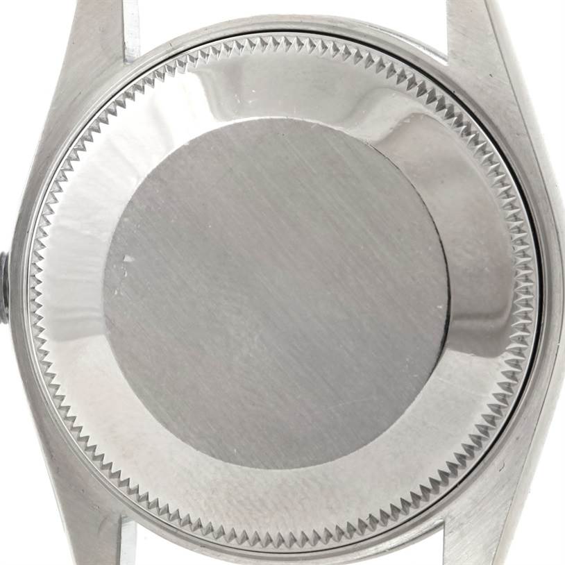 The image shows the back case of a Rolex Oyster Perpetual 67180 Women's Stainless Steel Black Dial 67180 Women's Stainless Steel Black Dial watch viewed from a top-down angle.