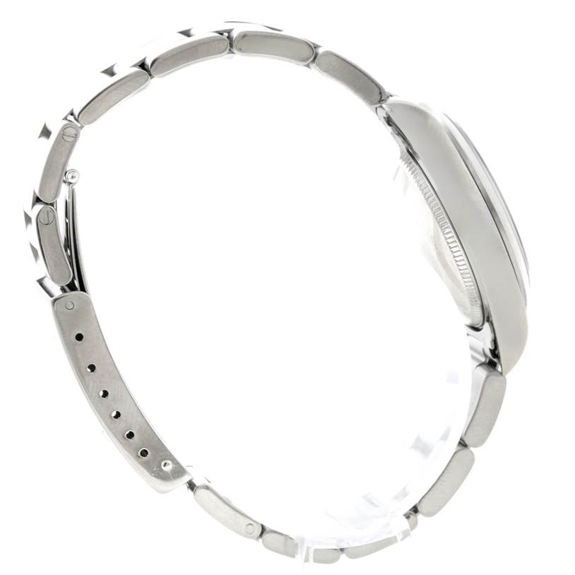 This side view of a Rolex Oyster Perpetual 67180 Women's Stainless Steel Black Dial 67180 Women's Stainless Steel Black Dial watch shows the bracelet and the profile of the case.